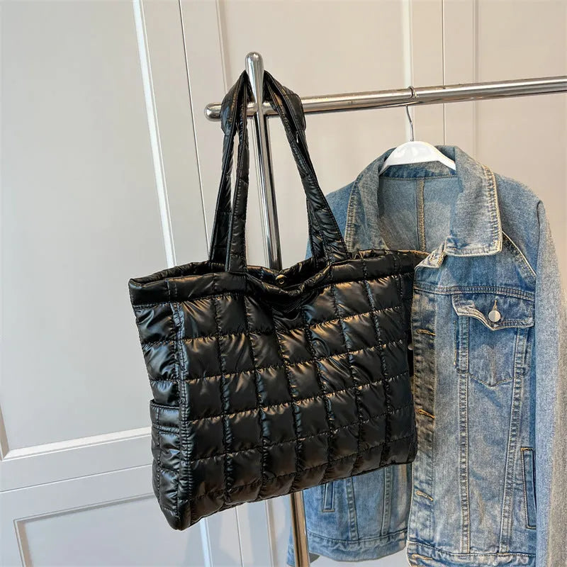 Large nylon plaid bucket shoulder bag in black with rhombus pattern, magnetic buckle, and soft handle.