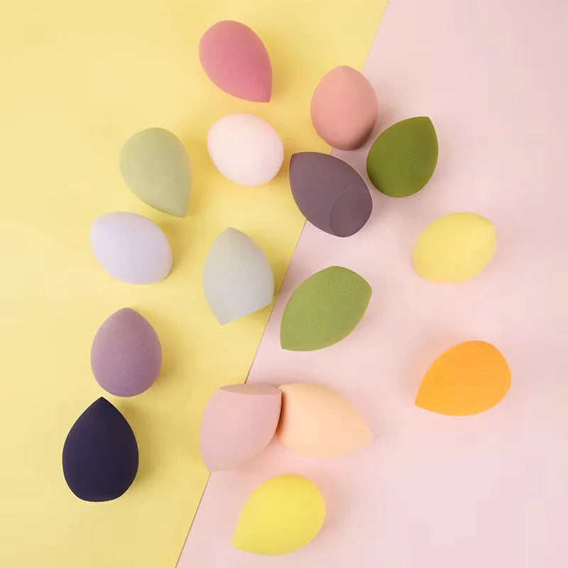 Set of 10 nude, pink and rose red hydrophilic non-latex makeup sponges in bevel drop and peach heart shapes.
