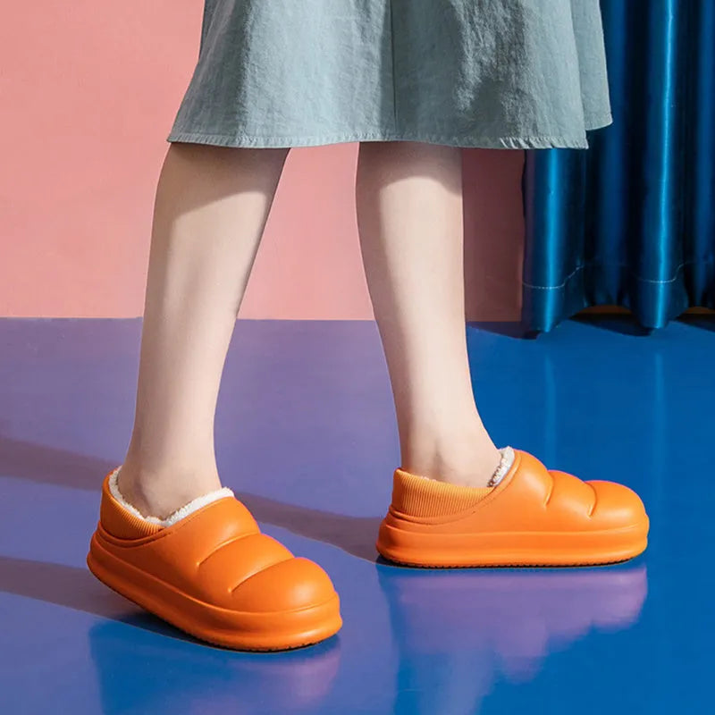A pair of waterproof EVA garden slippers with a plush lining, shown in a solid colour with a non-slip sole.