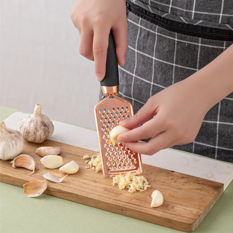 Seven-piece stainless steel kitchen tool set with rose gold finish and copper plating elements