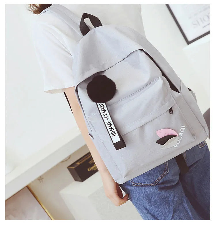 Canvas college schoolbag with leaves pattern showing anti-theft features and adjustable shoulder straps