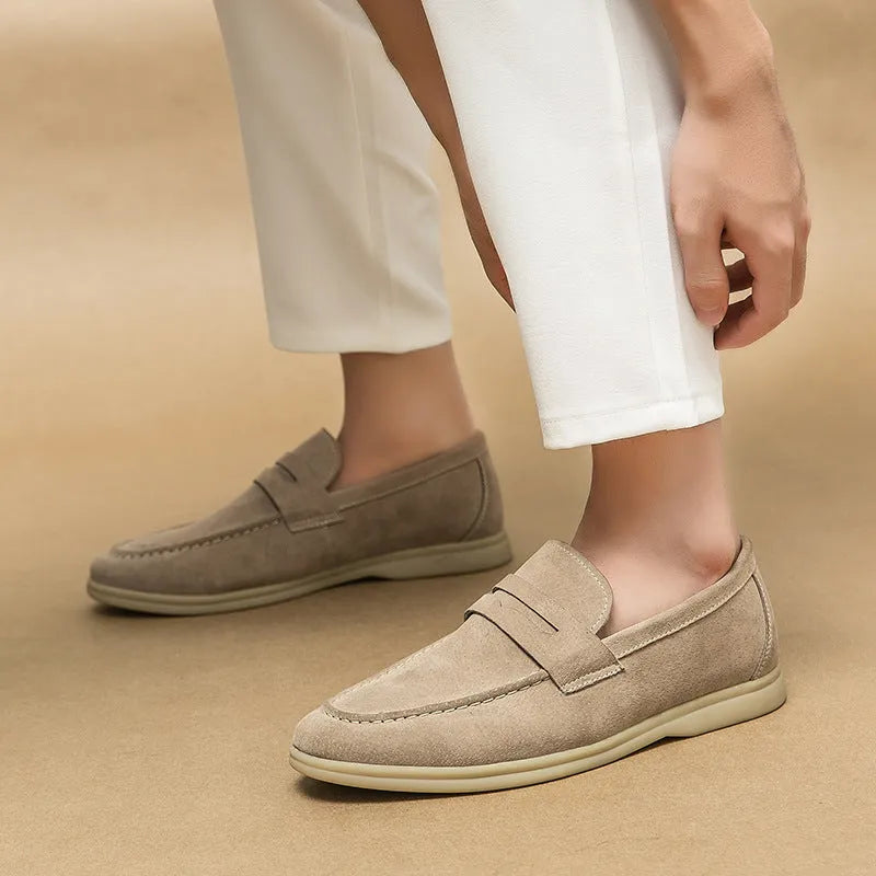 Men's beige leather slip-on casual shoes with a round toe and mid heel on a rubber sole.