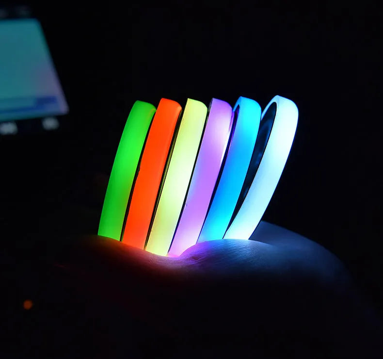 Colourful LED light-up coaster for car cup holder with solar panel and USB cable.