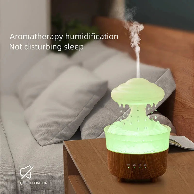 Wood grain white cloud-shaped humidifier diffuser with LED lights and water drop rain effect on a table.
