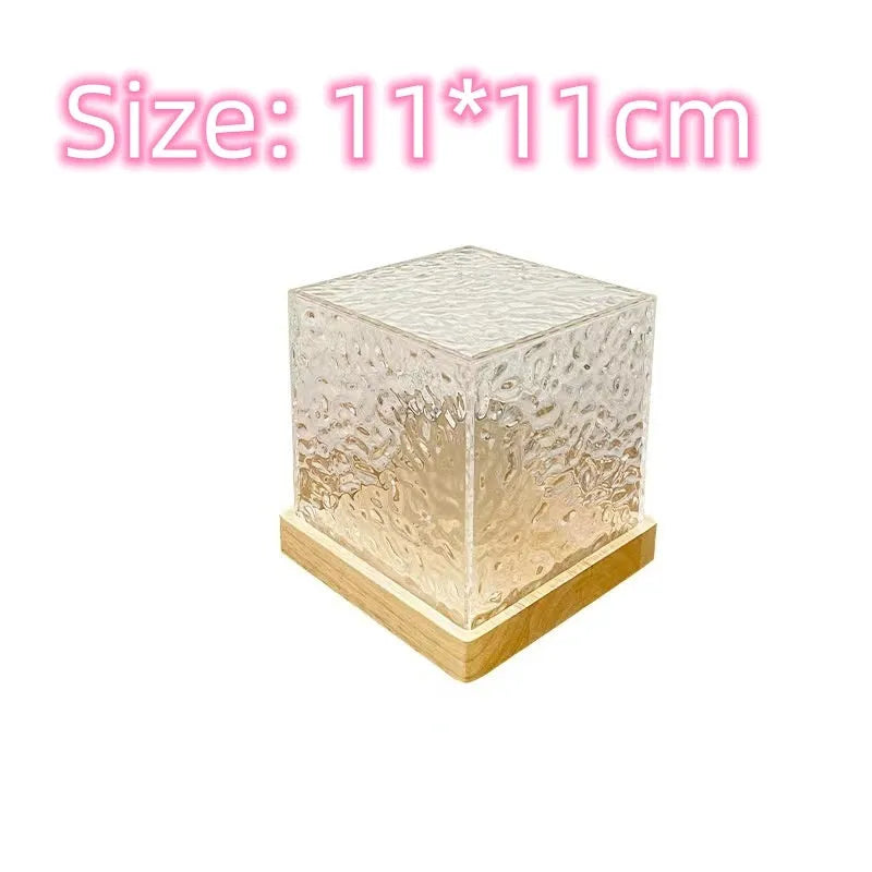 Rotating crystal table lamp projecting blue water ripple light pattern on wall