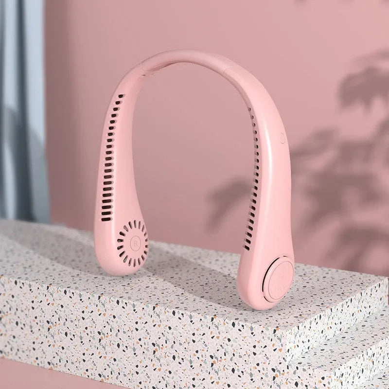Blue portable bladeless neck fan hanging around a person's neck, showing its compact design.
