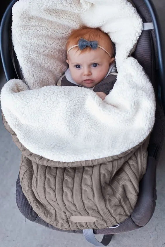 Envelope-style baby stroller sleeping bag in a plain colour, shown on a pram with lamb cashmere lining visible.