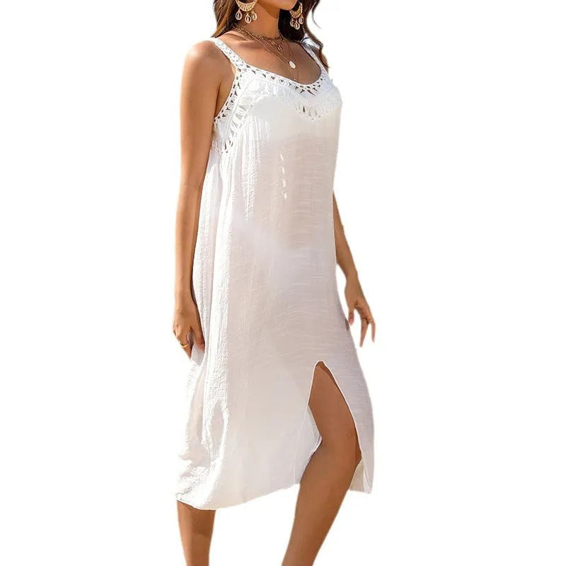 White suspender beach dress with woven crochet design and a bottom slit, modelled on an adult woman.