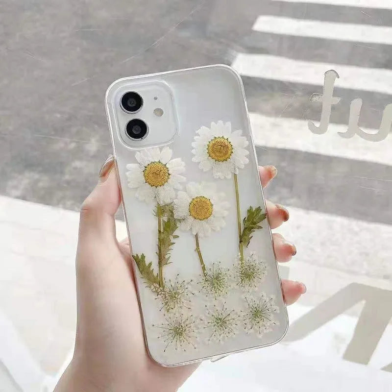 White epoxy daisy floral pattern on a glass back iPhone protective case.