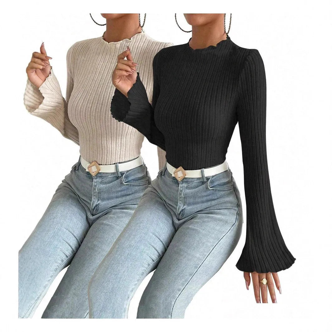 A black long sleeve slim fit top with round neck and lantern sleeves on a model.