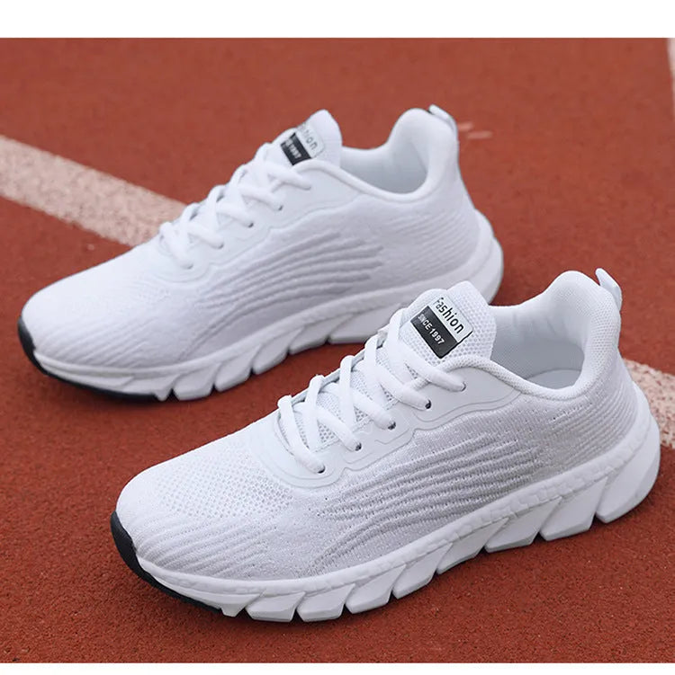 Women's low-top platform sneakers in black and white with cross-strap detail and MD sole.