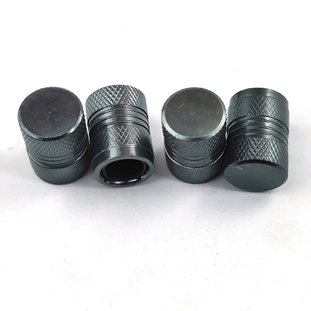 Aluminium car tyre valve cover in black, 17mm length, on a tyre valve stem