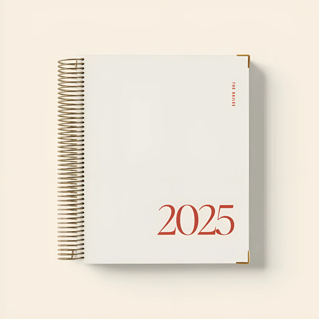 Cherry red spiral-bound coil notebook with wire binding lying flat on surface