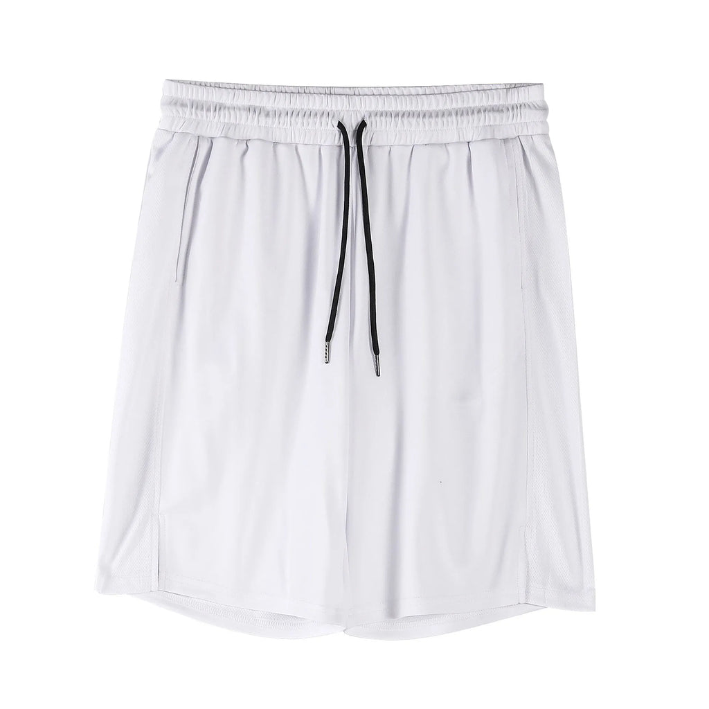 Man wearing black loose-fit mesh capri shorts with an elastic waist for sports.
