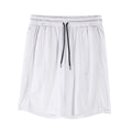 Man wearing black loose-fit mesh capri shorts with an elastic waist for sports.
