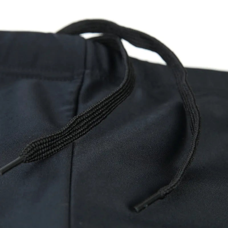 Men's plus size blue fire pattern swimming trunks and cap on a black background.