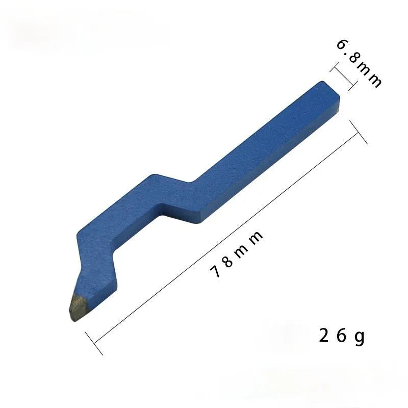 Curved character alphanumeric steel stamping tool for jewellery on a workbench.
