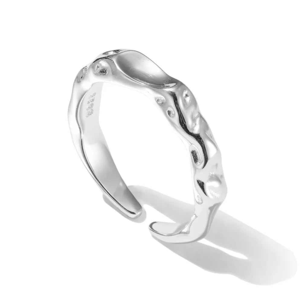 Irregular silver opening adjustable ring for women with electroplated finish on plain background