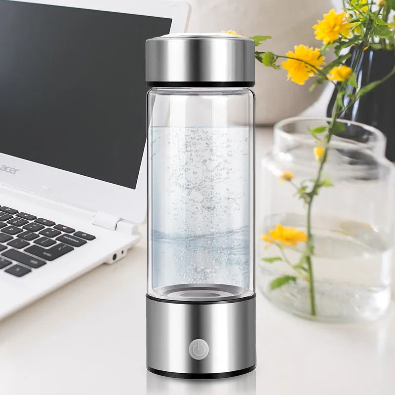 Silver hydrogen water bottle with electric generator, borosilicate glass cylinder.