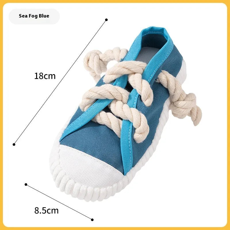 Plastic dog chew toy in slipper shape with sound feature, shown in yellow, black, and blue colour options.
