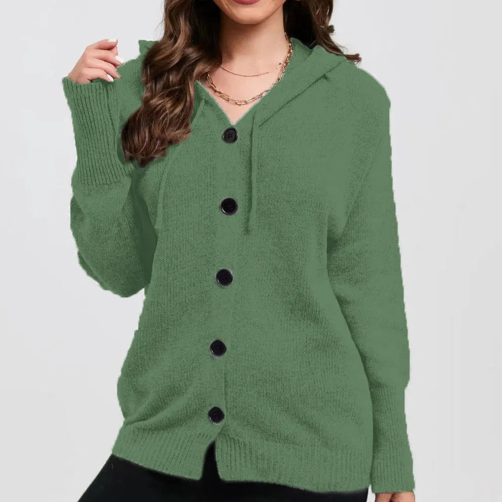 A woman wearing a loose-fit, solid-colour hooded cotton cardigan sweater.