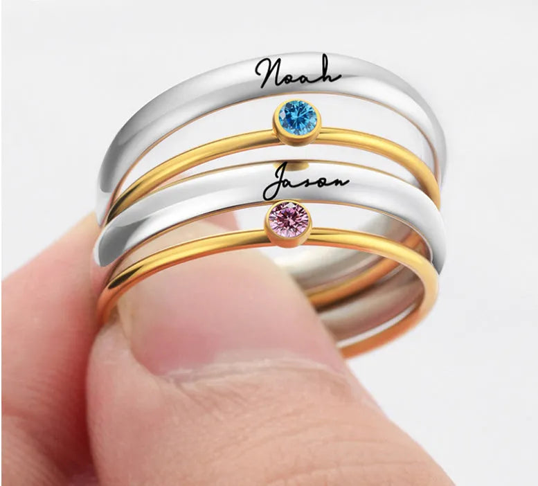 Geometric titanium steel ring with December birthstone colour and engraved gold lettering on band.