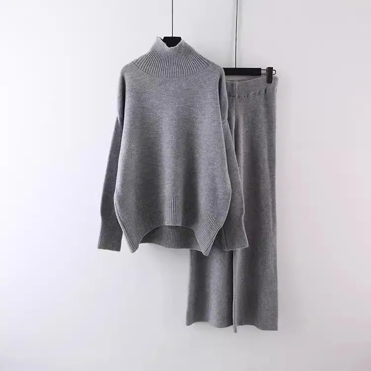 Women's beige acrylic sweater and wide-leg trousers casual two-piece set on a hanger.