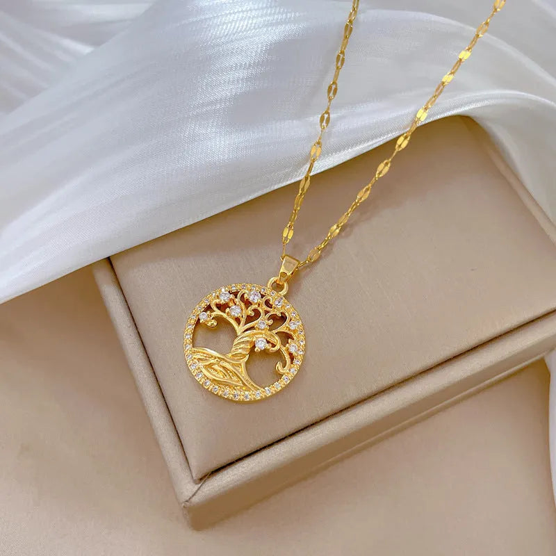 Gold-plated necklace with lucky tree rhinestone pendant and mother pearl centrepiece on an adjustable chain.