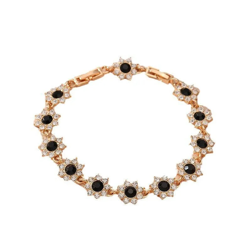 Women's floral charm bracelet in gold or silver electroplate with coloured gemstone effects.