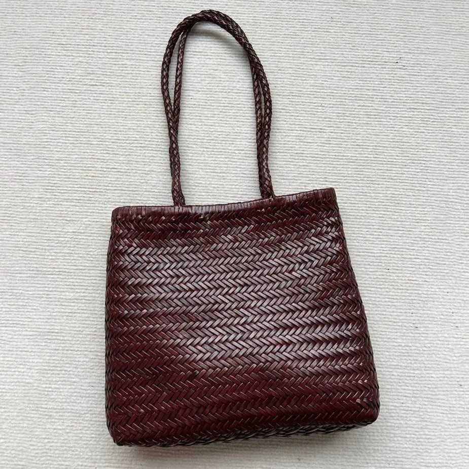 Brown woven genuine cowhide leather tote bag with a front pocket.