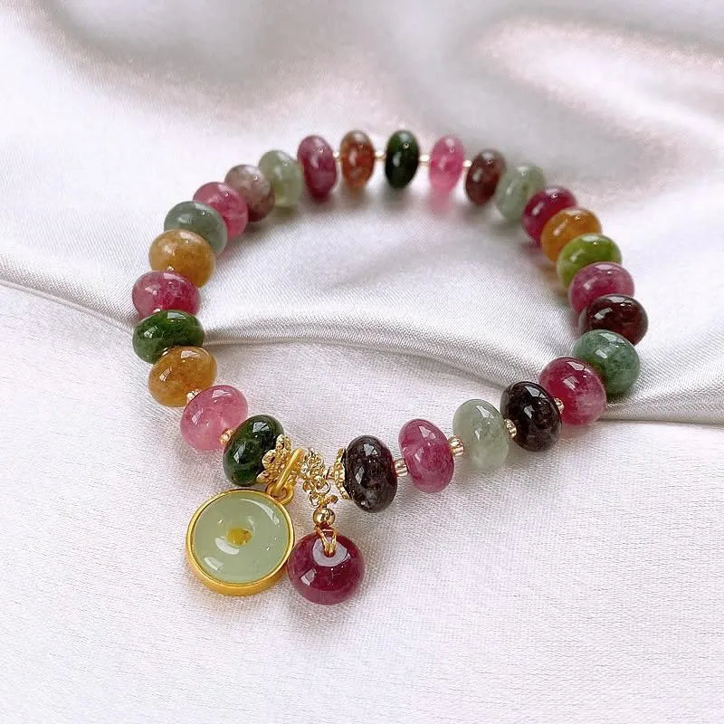 Colourful tourmaline bracelet with rabbit pendant and round abacus beads on wrist