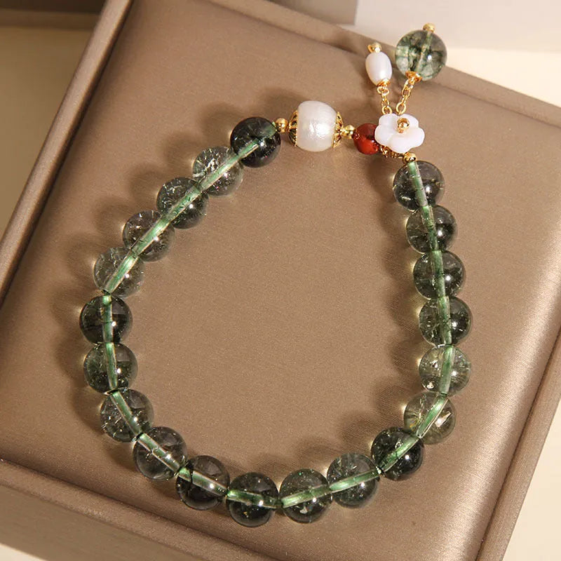 Green phantom quartz crystal bracelet with Bells of Ireland and shell flower design