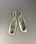 A pair of women's geometric-shaped alloy earrings with a two-tone marble pattern finish.