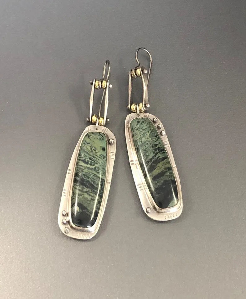 A pair of women's geometric-shaped alloy earrings with a two-tone marble pattern finish.