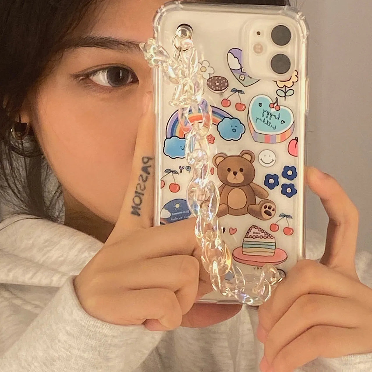 Bear chain and pendant attached to a Japanese Korean cartoon style protective case for an iPhone.