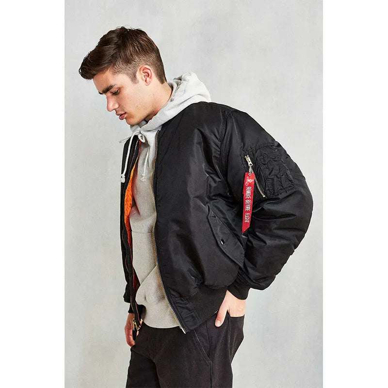 Men's reversible nylon pilot jacket in army green, shown on a model, displaying its loose fit and double-sided design.