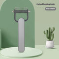 Green and grey pet hair unknotting comb for dogs with stainless steel teeth on a PP plastic handle.