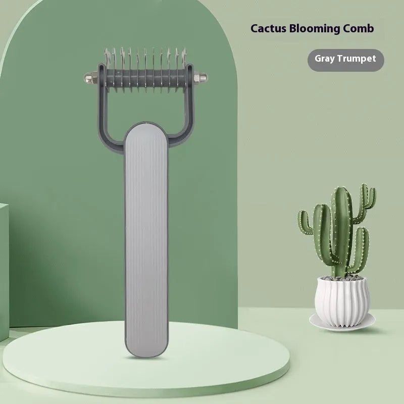 Green and grey pet hair unknotting comb for dogs with stainless steel teeth on a PP plastic handle.