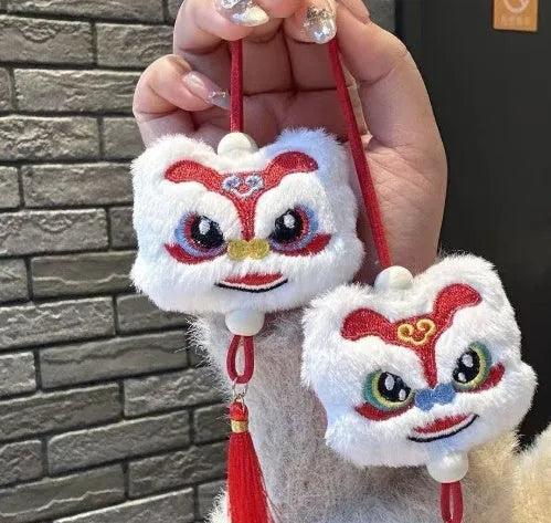 Handmade Chinese lion plush ornament with star stone details on blue and yellow keychain