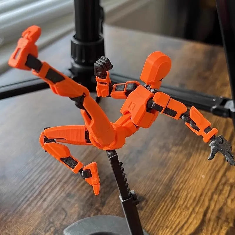 Multi-jointed 3D printed robot action model with movable limbs on a desk.