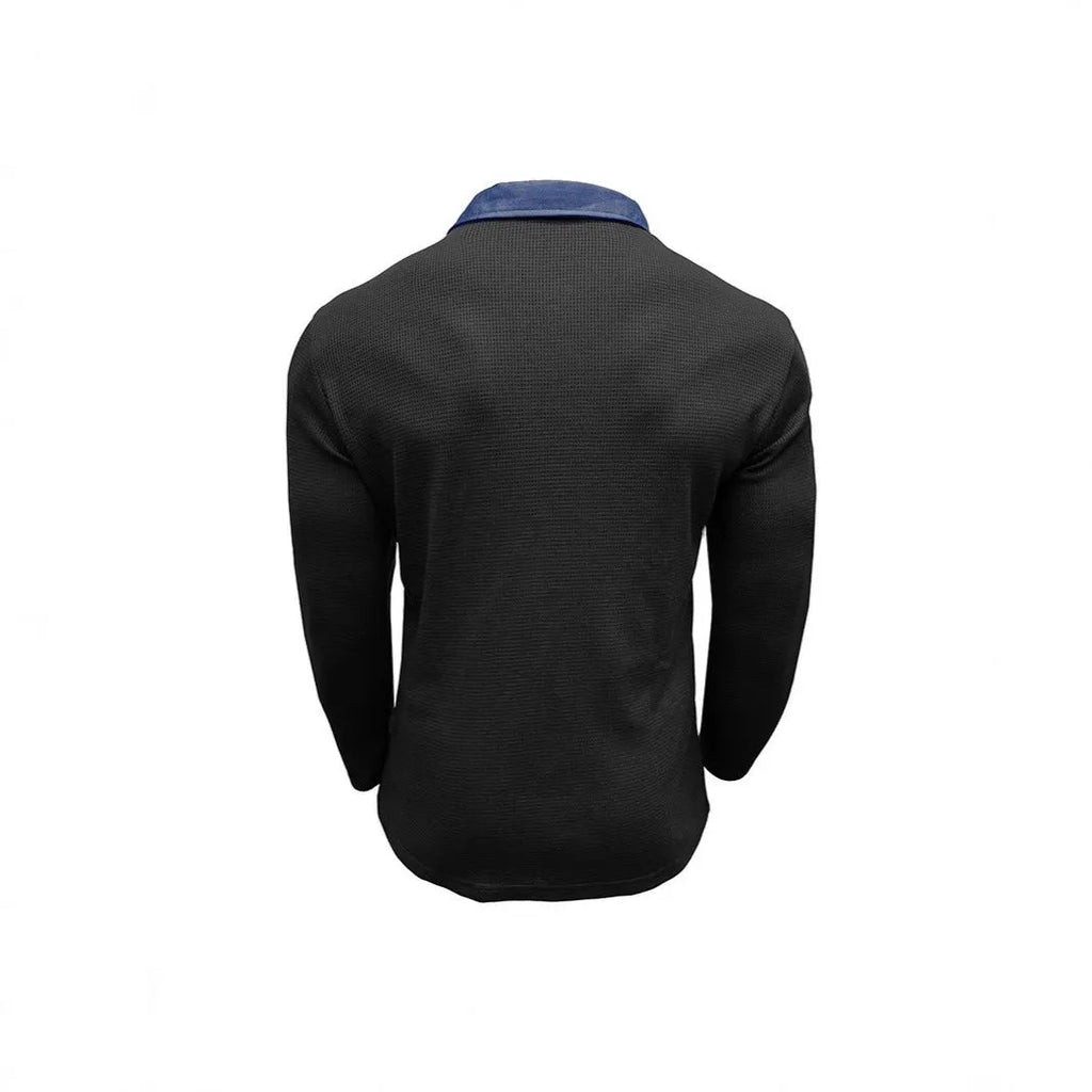 Man wearing a long-sleeved waffle knit polo shirt with an asymmetric collar in a dark colour.
