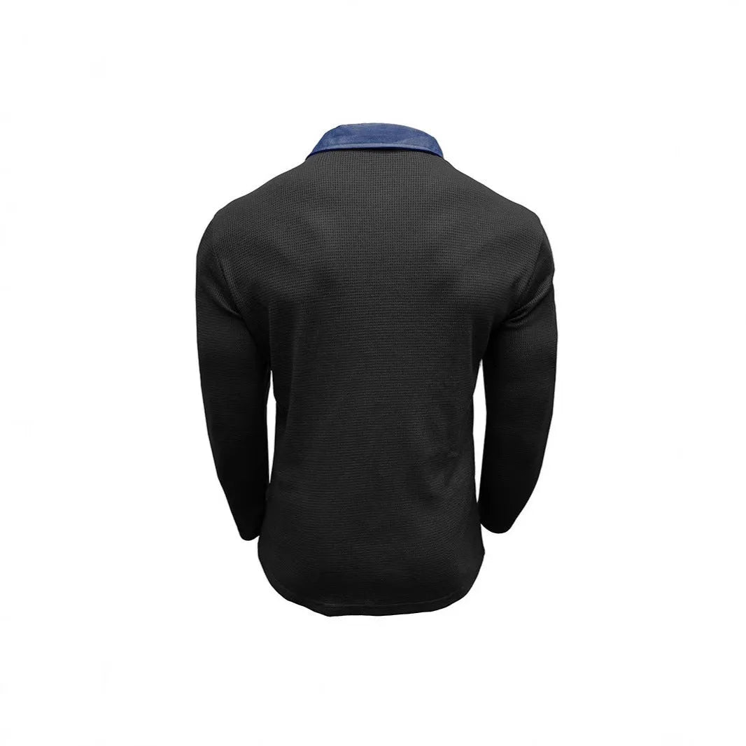 Man wearing a long-sleeved waffle knit polo shirt with an asymmetric collar in a dark colour.