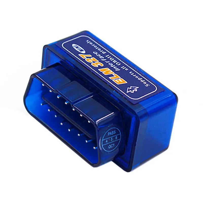 Small black ELM327 OBD2 Bluetooth car diagnostic scanner plugged into a vehicle port.