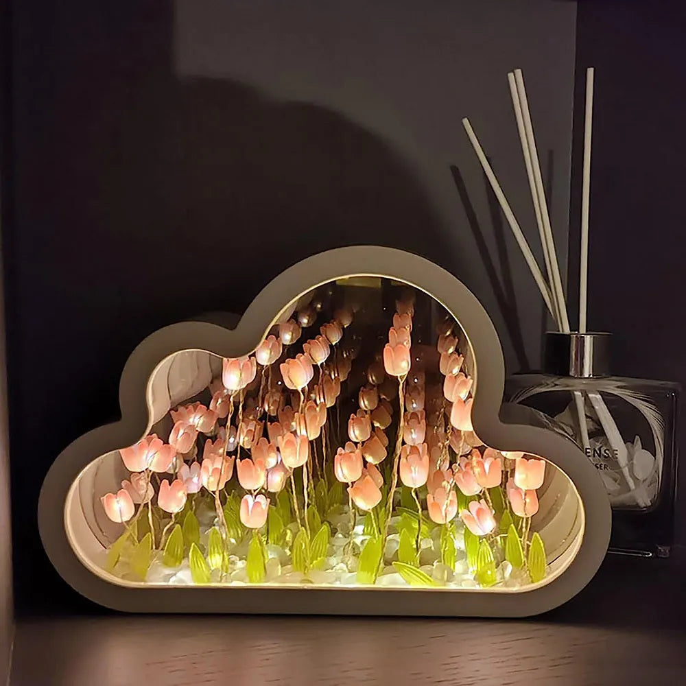 Assembled pink tulip-shaped night lamp with LED light, mirror front, and small photo frame on a desk.