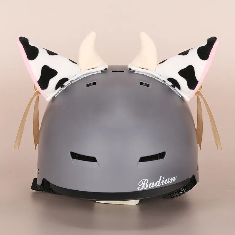 Soft plush cartoon character cover on a motorcycle helmet, showing size M and decorative ear sections.