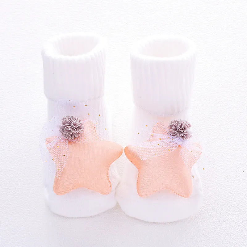 Cotton baby socks with non-slip soles in multiple designs including bows, stars, and animal prints.
