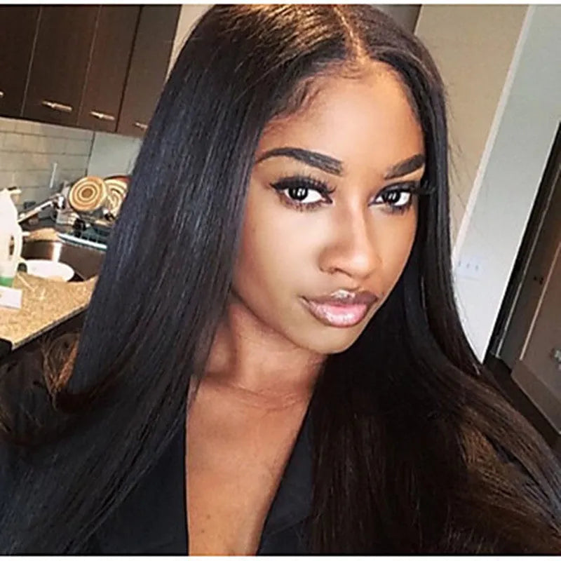 Long straight black synthetic ladies wig with a centre part, displayed on a wig stand.