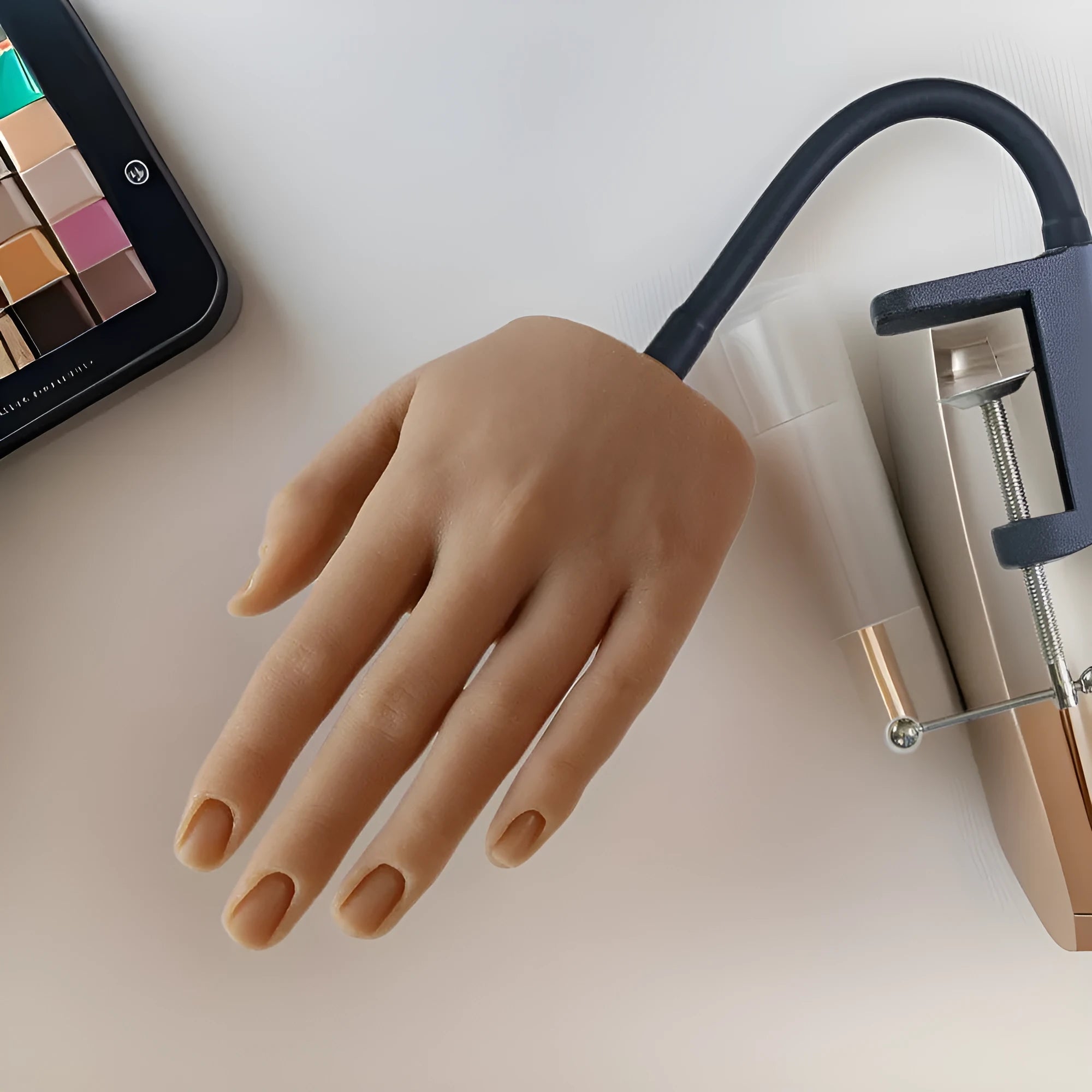 Realistic silicone nail art practice hand model with flexible fingers on a table
