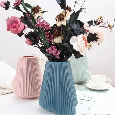 Blue melamine plastic decorative flower vase measuring 16cm by 20cm on a desktop.