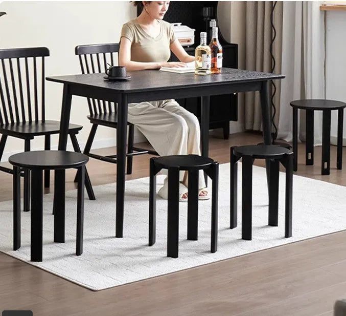 Stackable round iron dining stool in a modern style, shown in a choice of four colours.